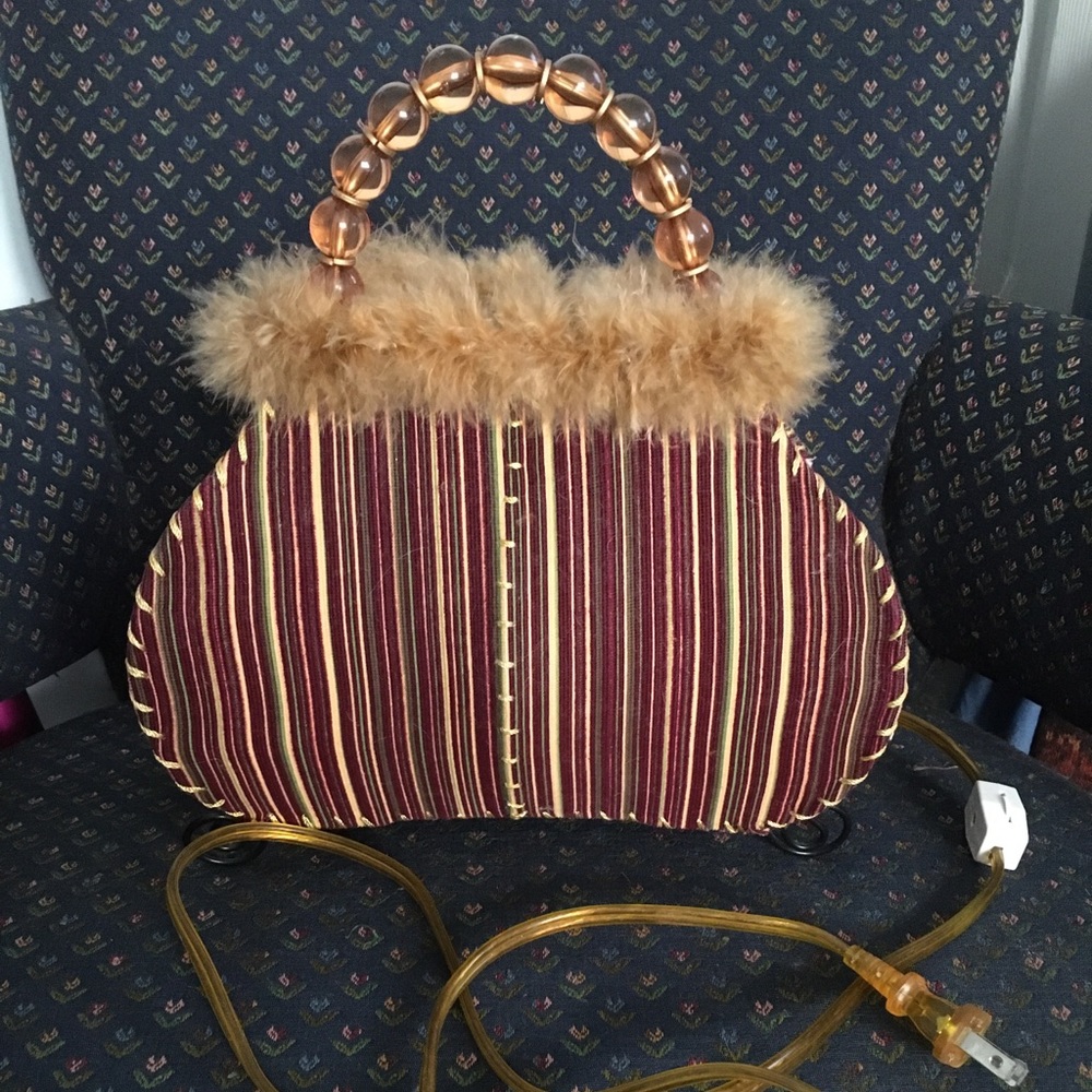 Novelty lamp designed as a pocketbook with faux fur trim.